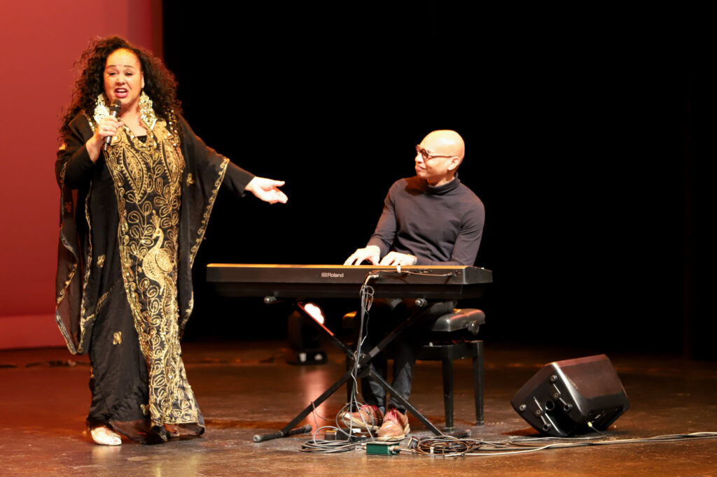  A female performer singing and a male performer playing a piano keyboard at the Black History Month celebration at Maple, Ontario
