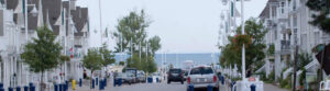 A view of the Nautical Village in Pickering, Ontario, along with cars passing by and residents walking